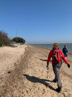Striding along the beach by West Mersea, south coast of the Island